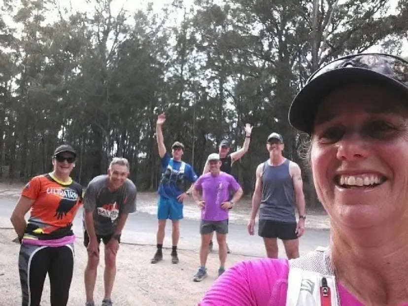 Runners celebrating with their arms raised at the end of a run