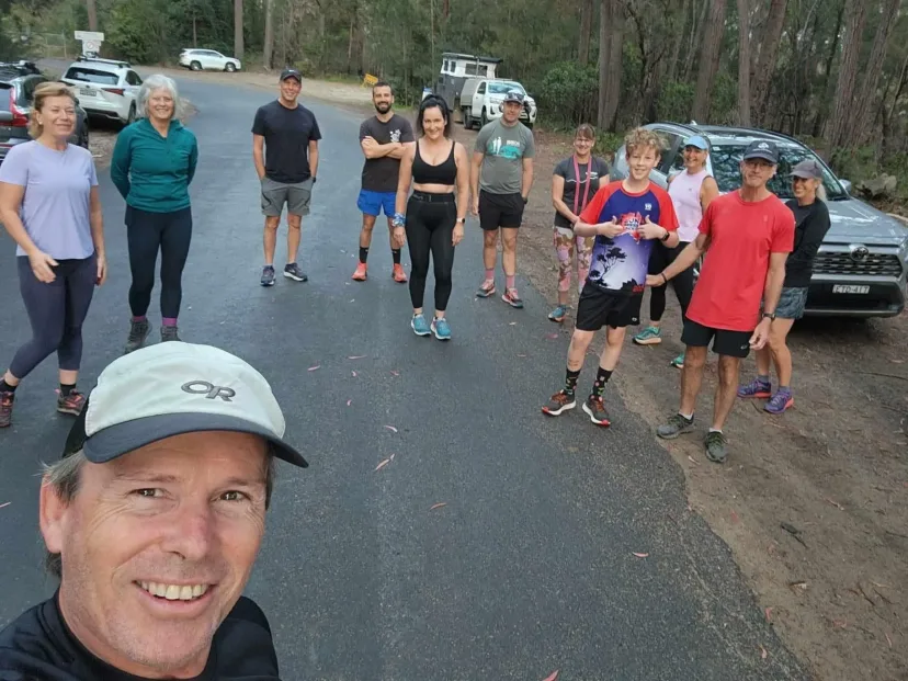 Runners setting off along a road, with a selfie in the foreground