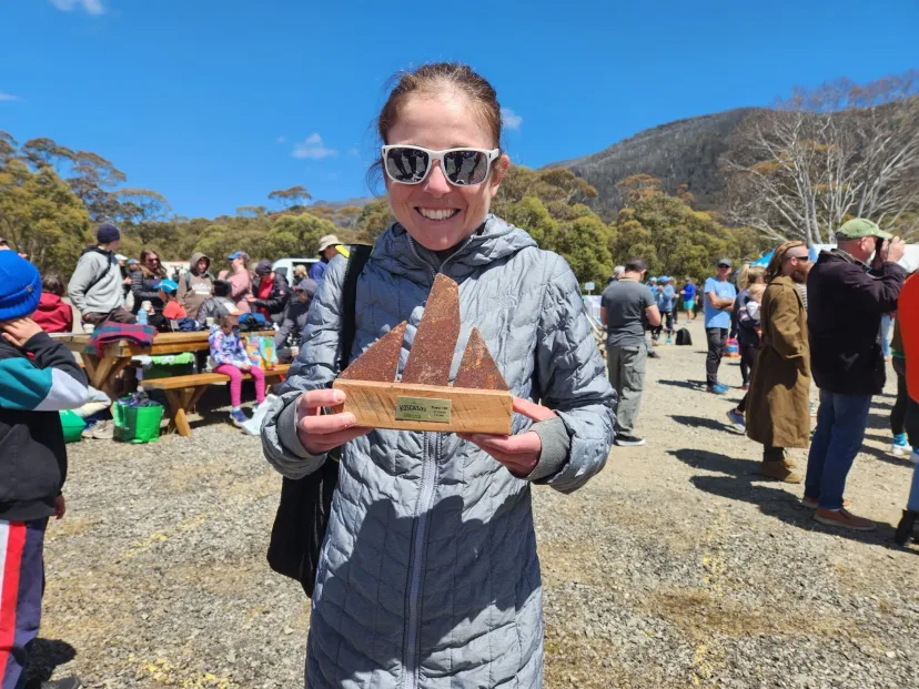 Club member holding a timber trophy at an event