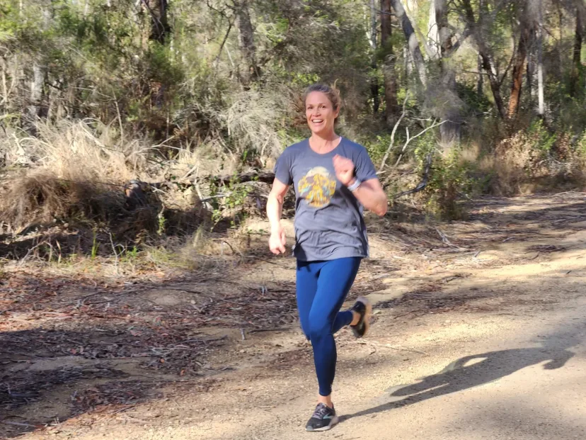Runner on a sandy trail through low coastal scrub