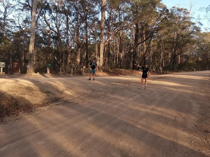 Two runners on the wide dirt fire trail on the Back Millingandi Loop