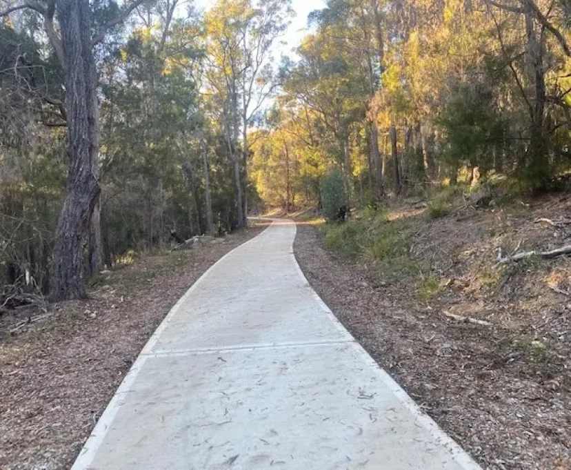 Concrete shared path winding through bushland between Kalaru and Tathra