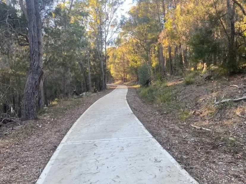 Concrete shared path winding through bushland between Kalaru and Tathra