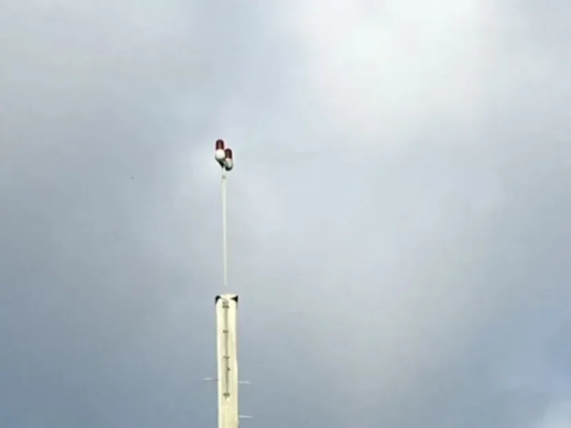 Navigation beacon tower against a grey sky on the Red Light route