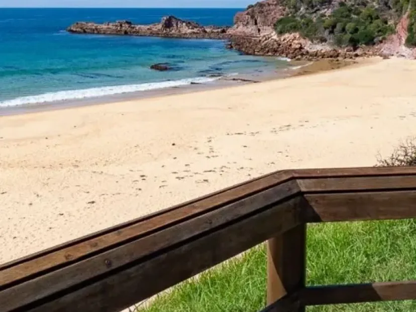 Beach and rocky point from the timber railing on the Tura to Bournda route