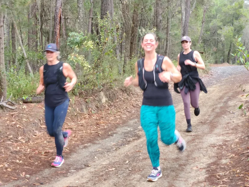 Group of club members running a bush trail