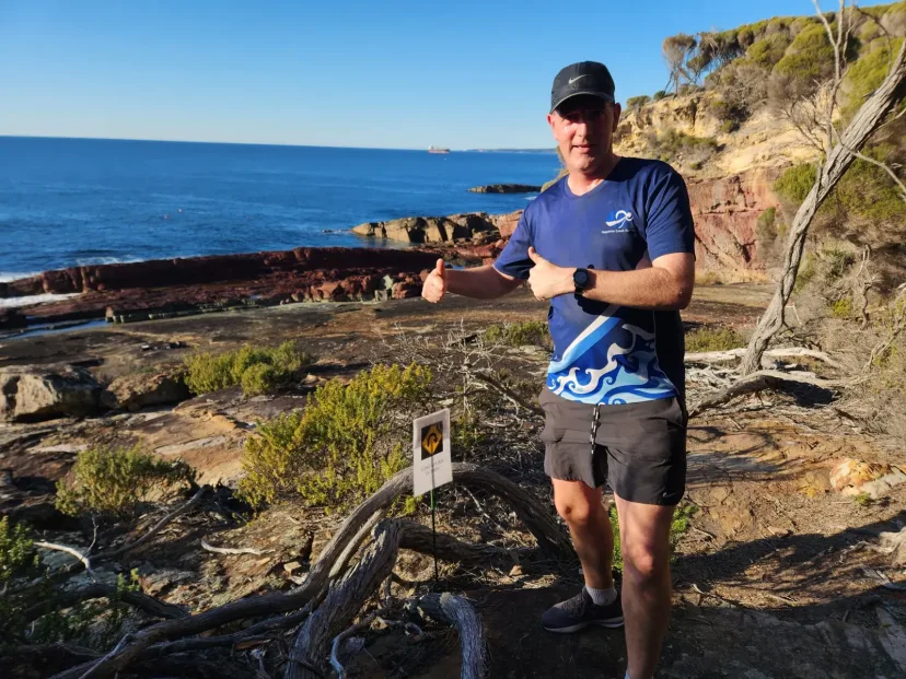 Club member running the coast path above the ocean
